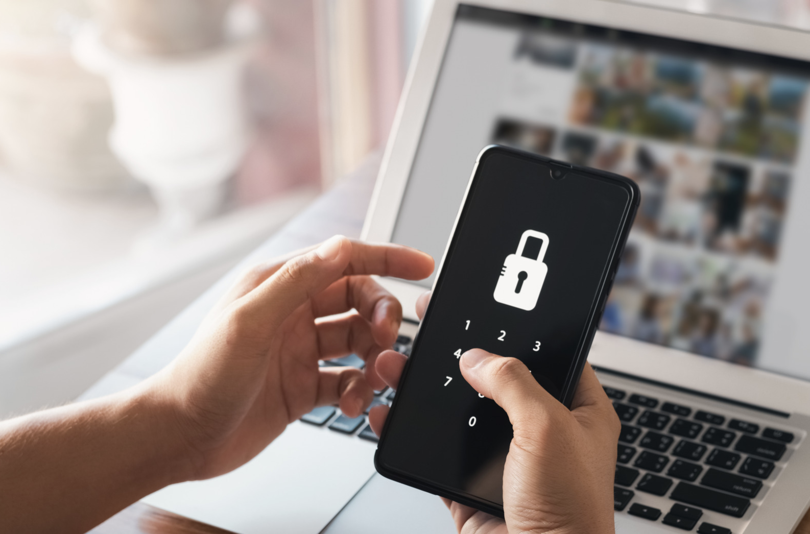 Person entering a passcode on a locked smartphone