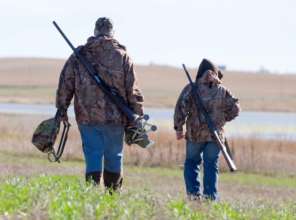 a grandpa hunting with his grandson 