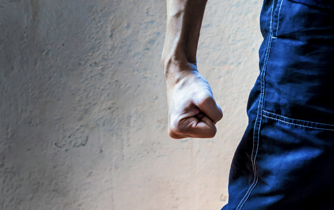 a man making a firmly gripped fist
