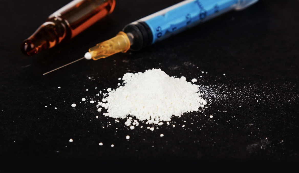 illegal drugs next to a syringe