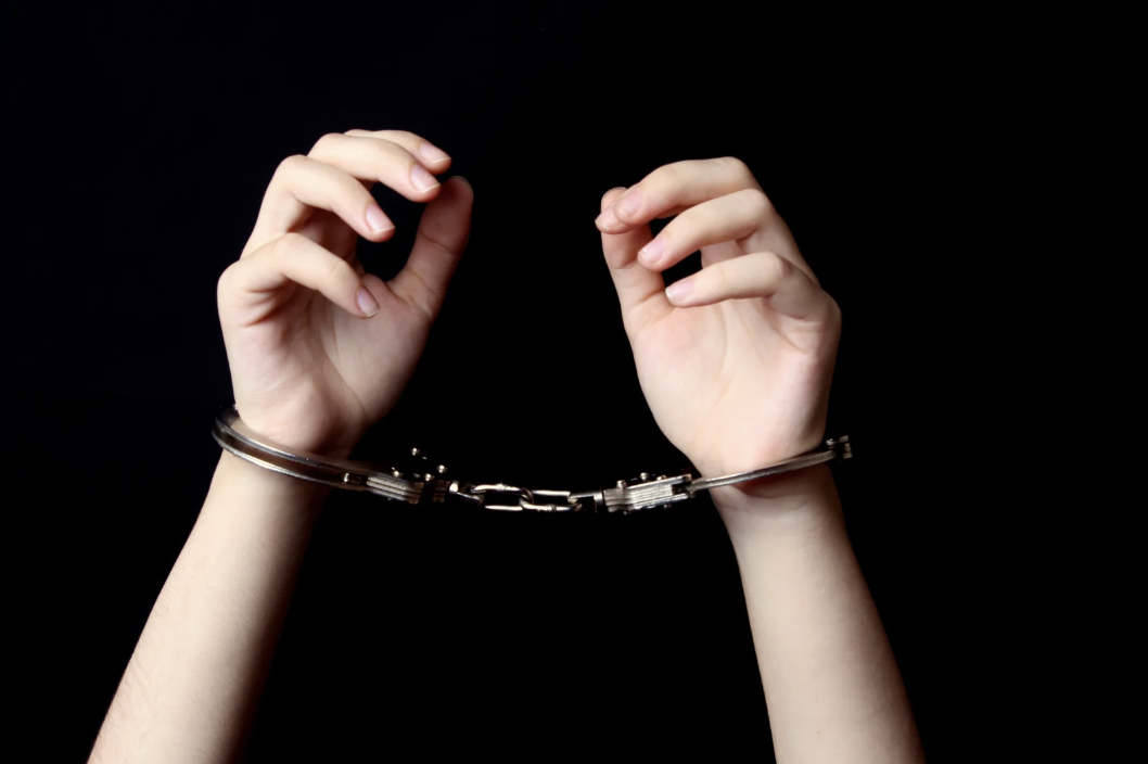 hands that are handcuffed, raised into the air