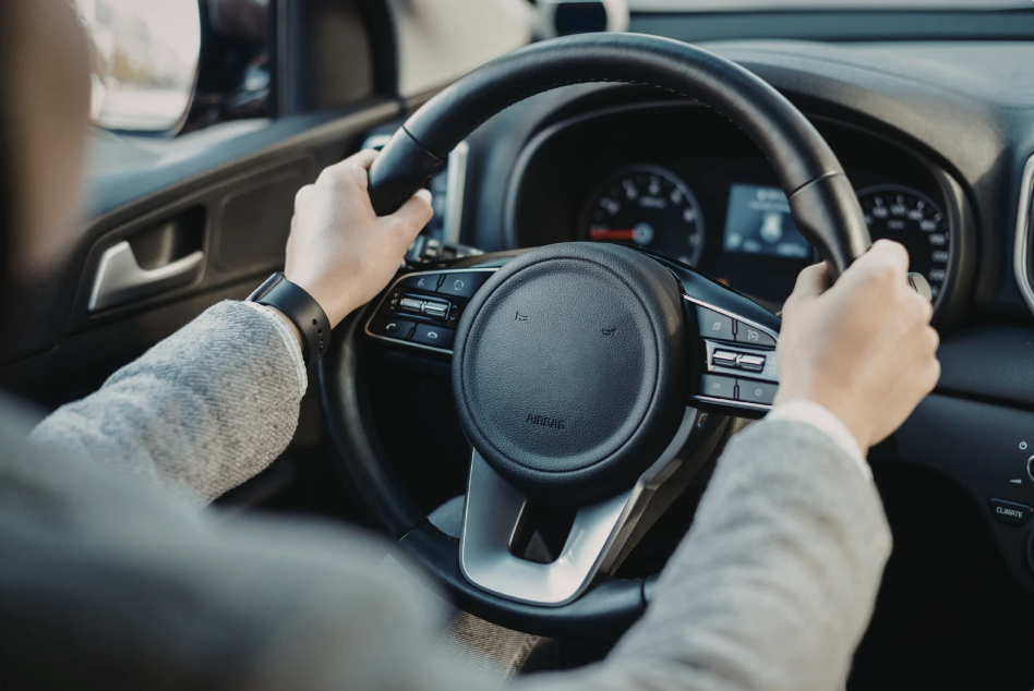 a third person visual of a person driving an unidentifiable car 