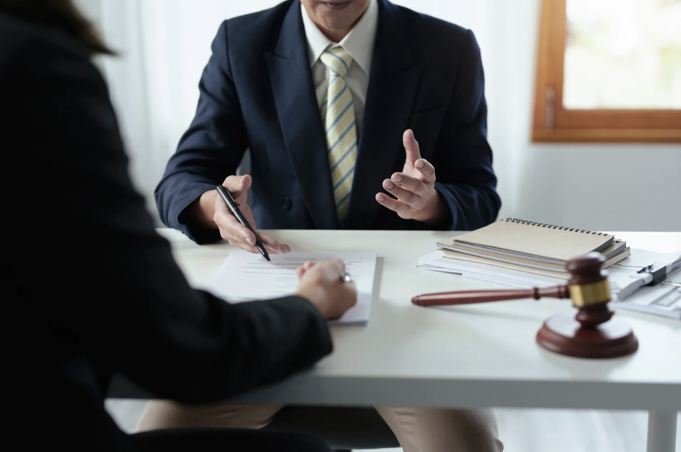 a legal consulting meeting between two people at a table