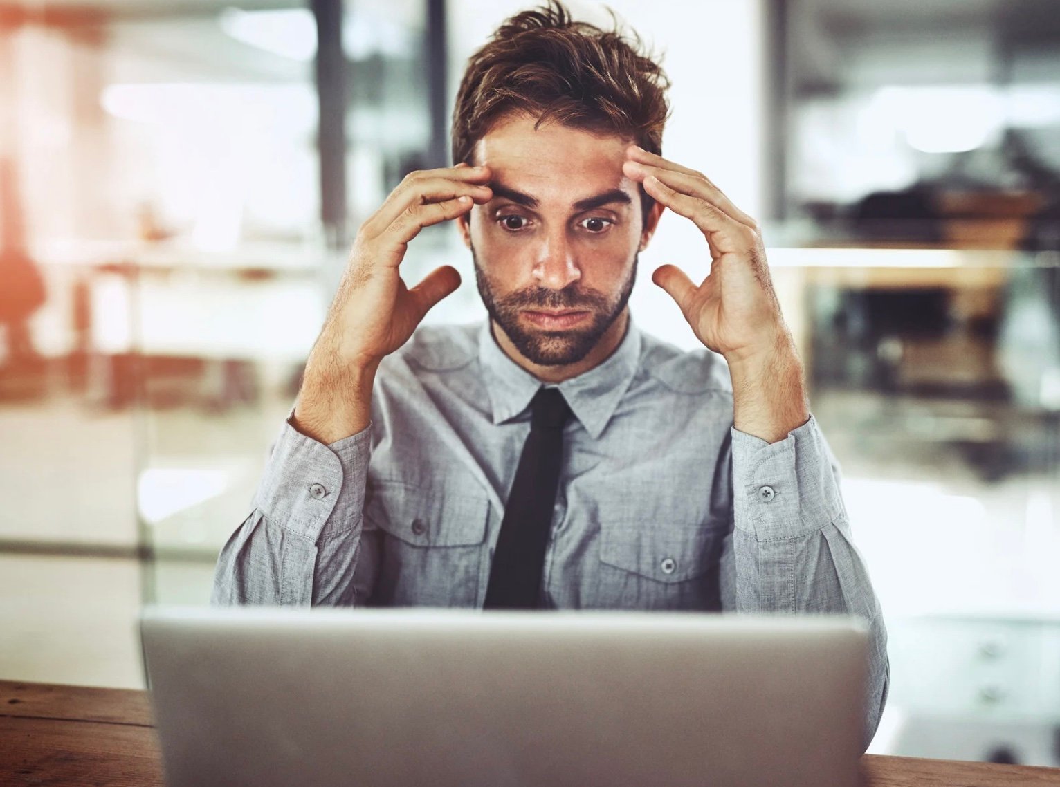 a man who is frustrated at the computer 
