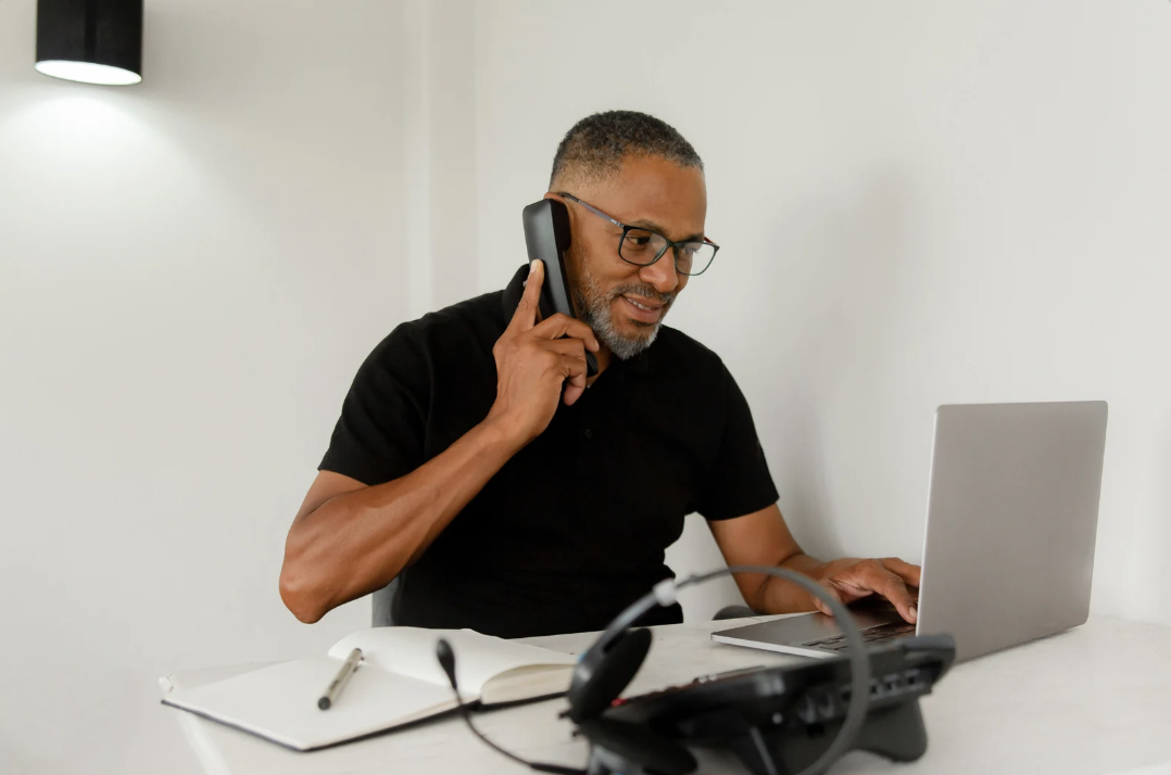 a man working in customer service on the phone 