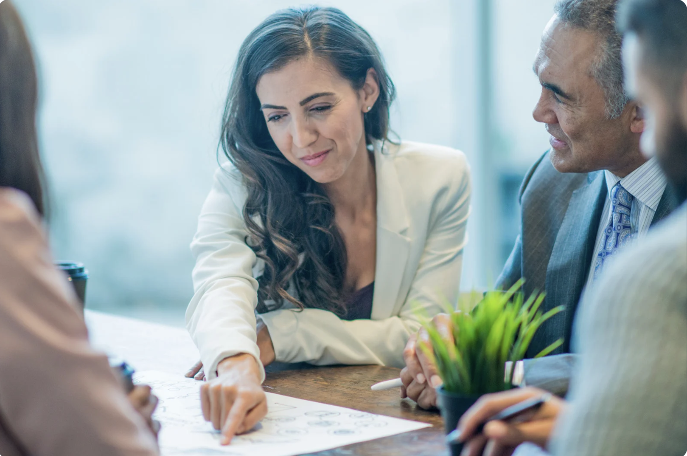 lawyers meeting together discussing paperwork together at a table