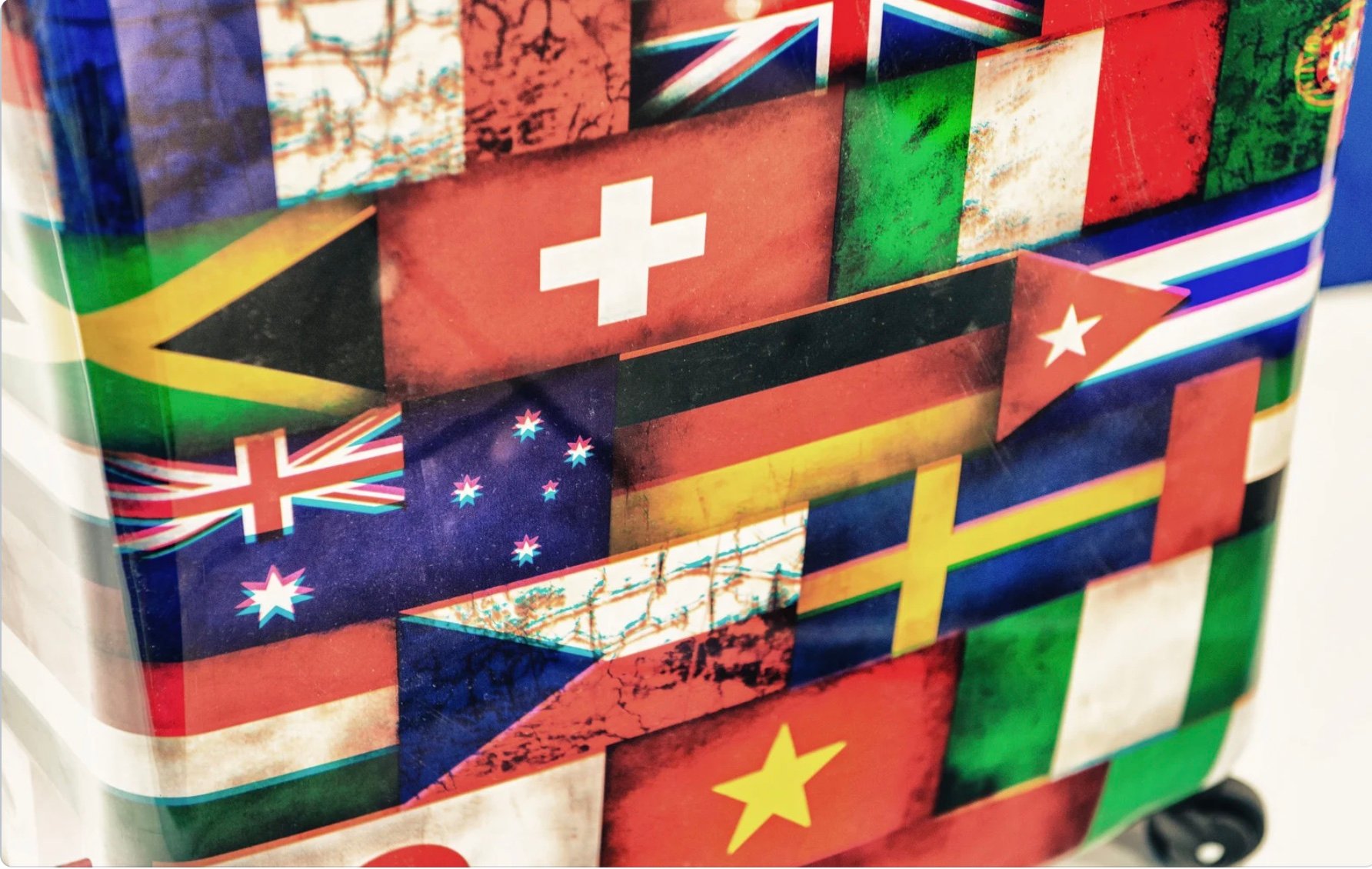 flags of multiple countries positioned together on a wall