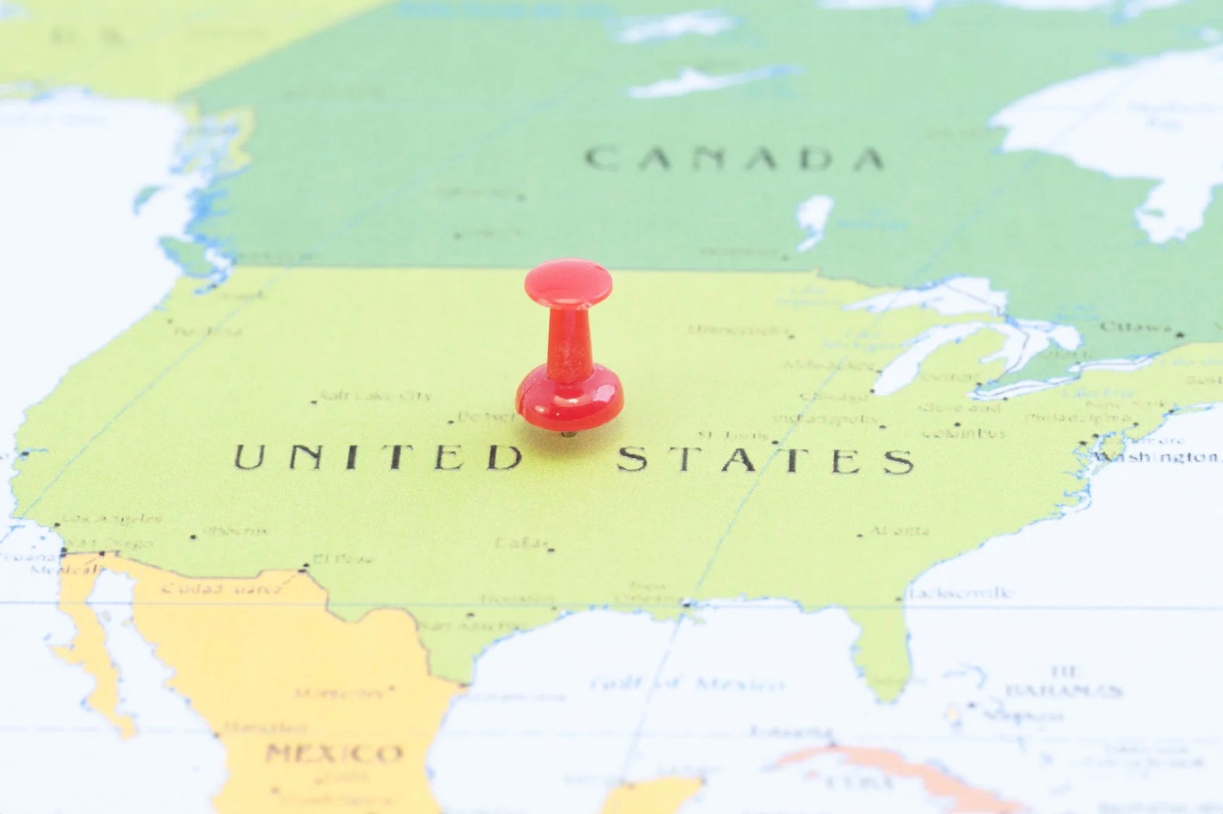 a map of the world with a push pin on the United States