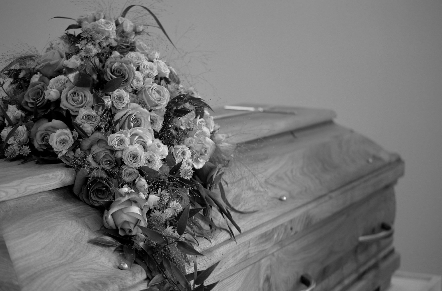 a casket with a bouquet on top