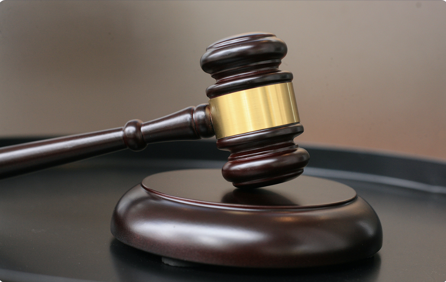 a judges gavel resting on the podium 