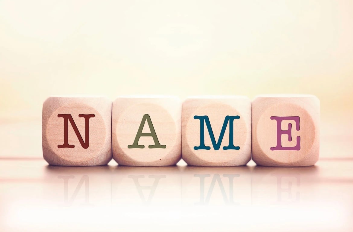 Wooden blocks, each with a letter from the alphabet; positioned together to spell the word 'Name'