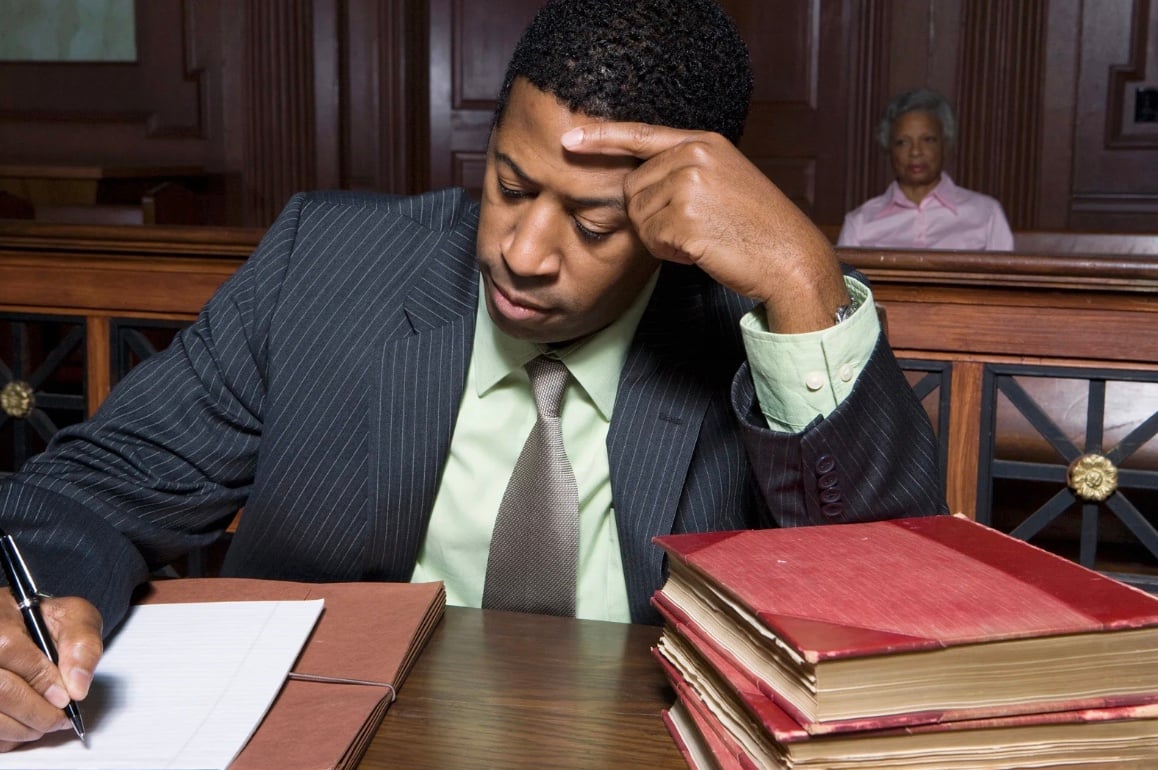 a man writing down in court