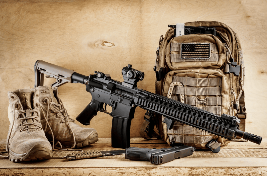 combat books next to an assault rifle and a combat backpack
