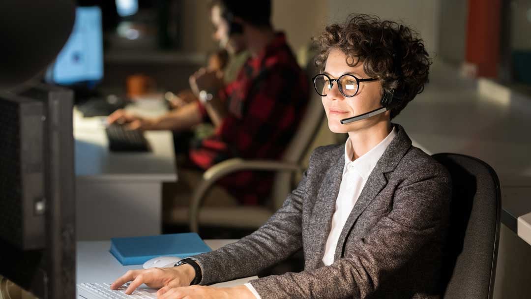 woman with headset at computer