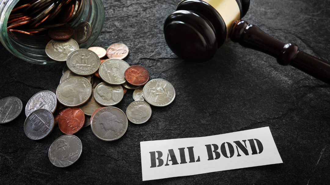 coins on a table next to gavel