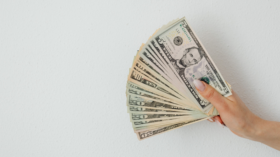 pile on cash in womans hand
