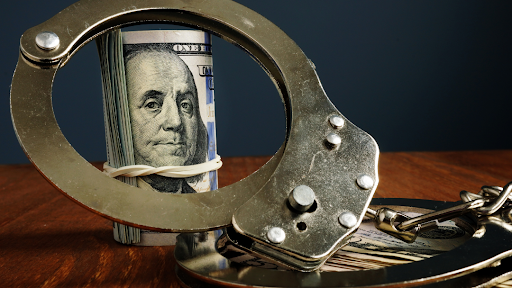 cuff with roll of money behind it