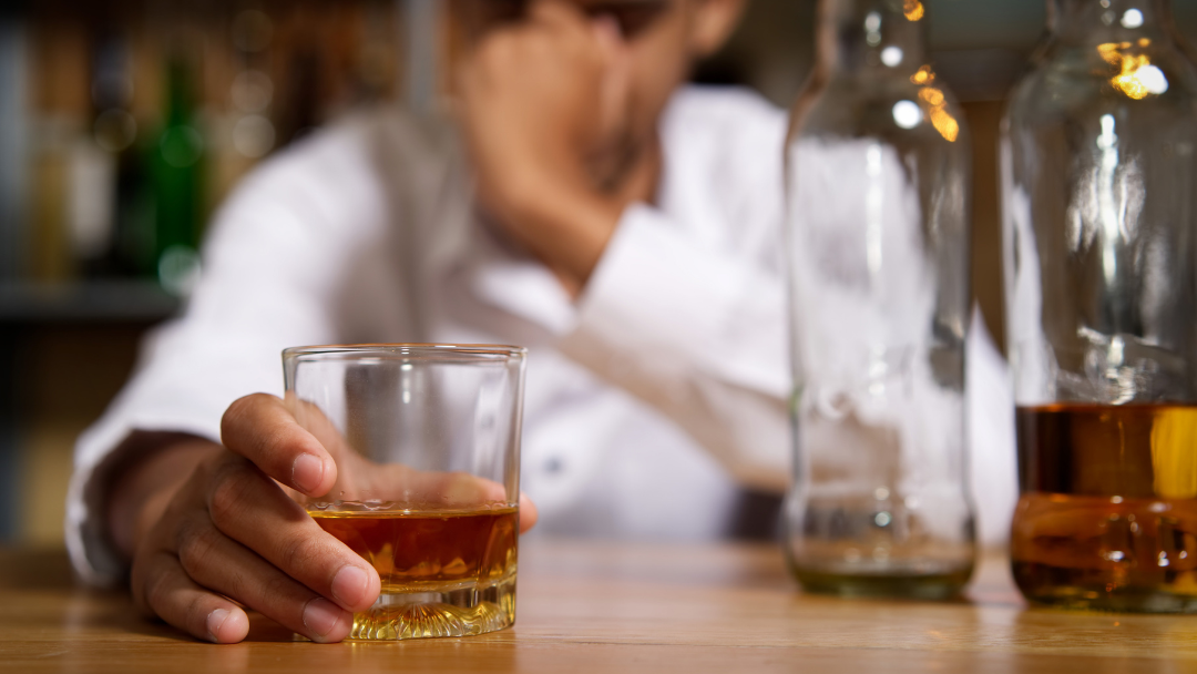 man drinking at bar