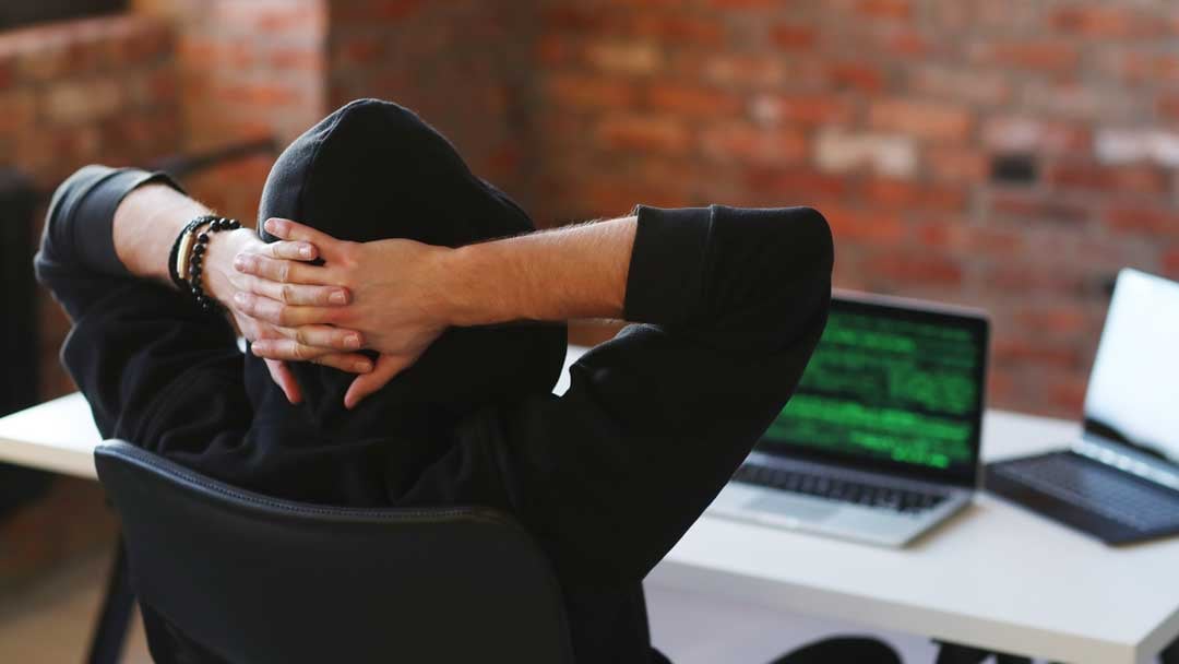 man sitting in front of a laptop