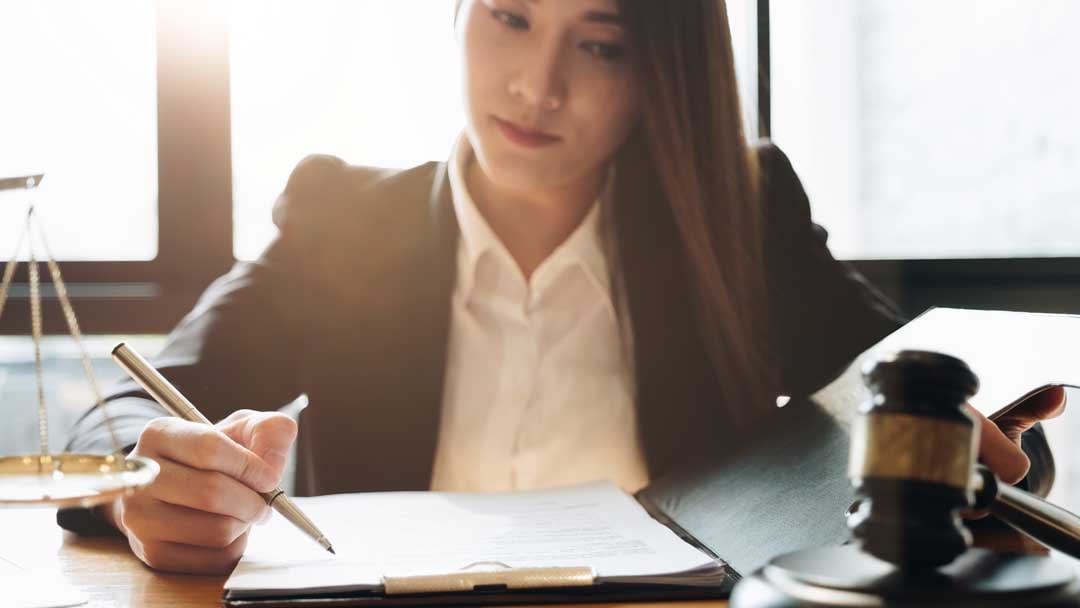woman sitting infront of a book