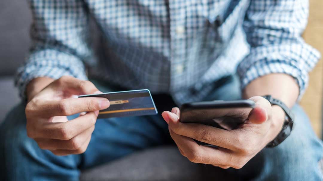 man with phone and credit card