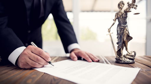 man signing contract