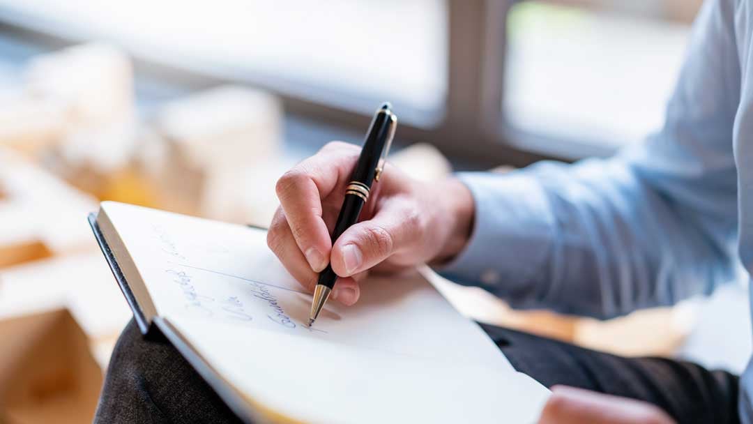 person writing on paper