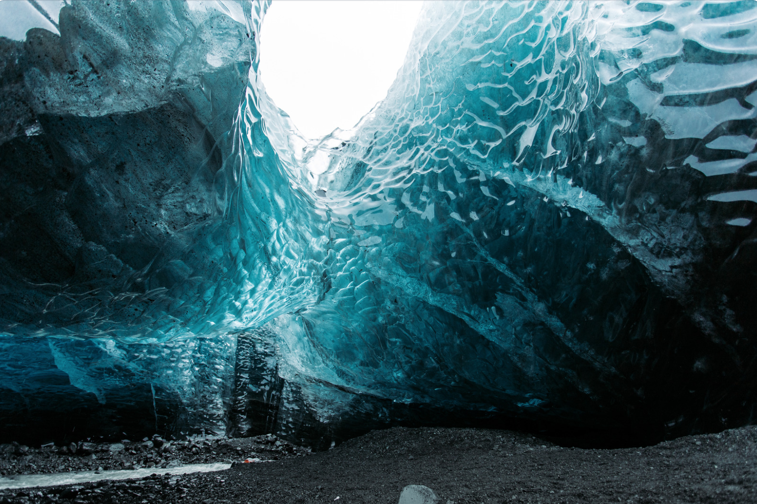 an ice crystal cave with sources of light shining through