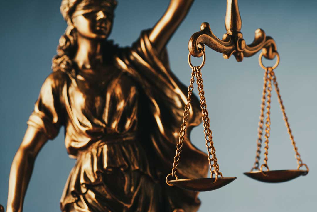 figure of justice holding the scales of justice representing bail reform